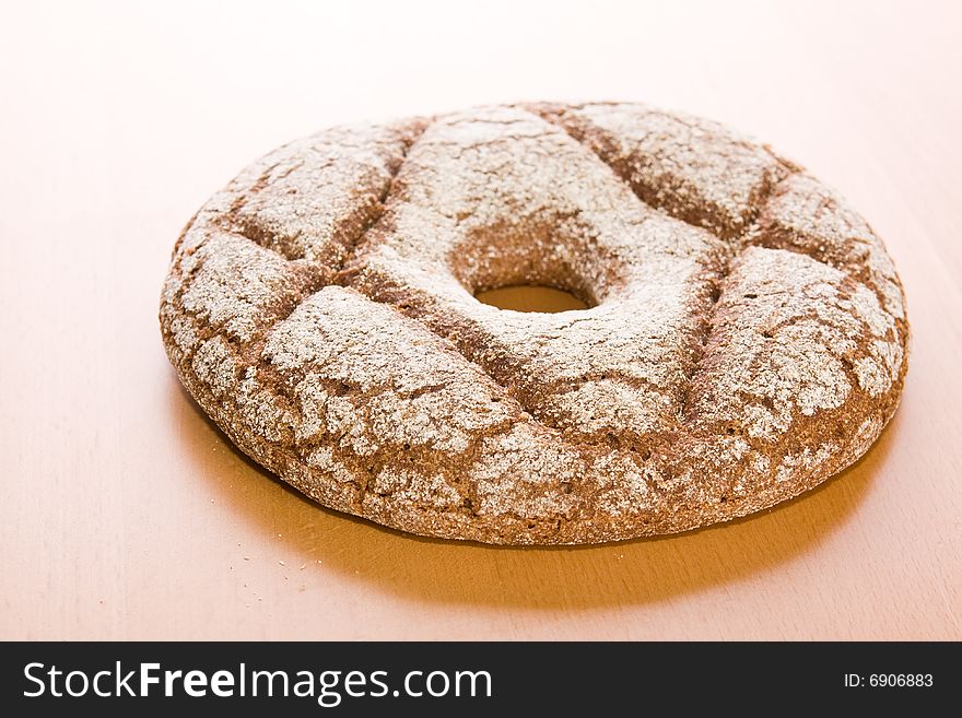 Fresh round rye bread on table
