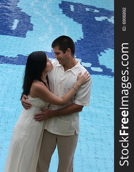 Bride and groom at the swimming pool - trash the dress trend. Bride and groom at the swimming pool - trash the dress trend.