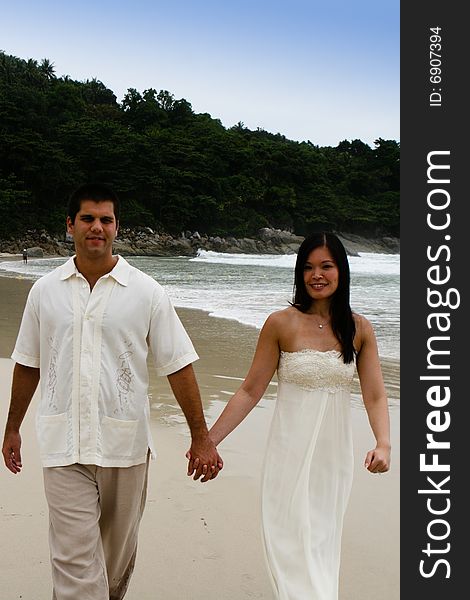 Portrait of an attractive bride and groom on the beach. Portrait of an attractive bride and groom on the beach.