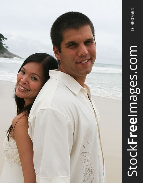 Portrait of an attractive bride and groom on the beach. Portrait of an attractive bride and groom on the beach.