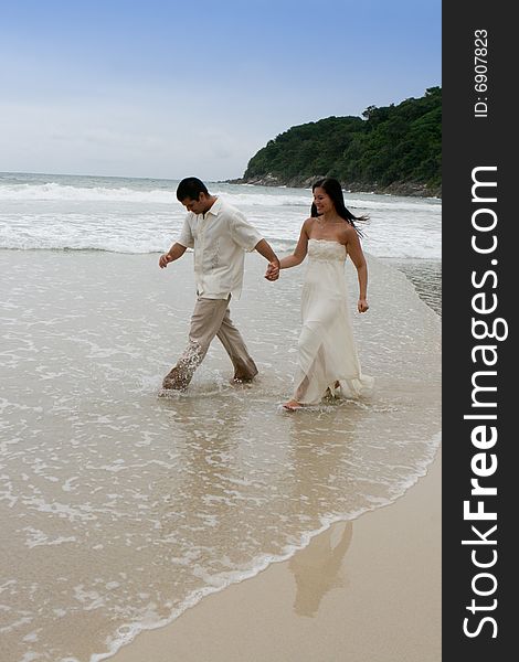 Portrait of an attractive bride and groom on the beach. Portrait of an attractive bride and groom on the beach.