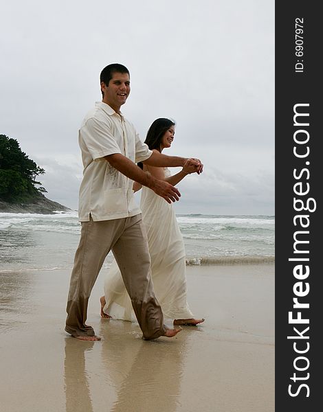 Portrait of an attractive bride and groom on the beach. Portrait of an attractive bride and groom on the beach.