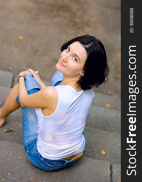 Portrait of pretty woman sitting on a staircase