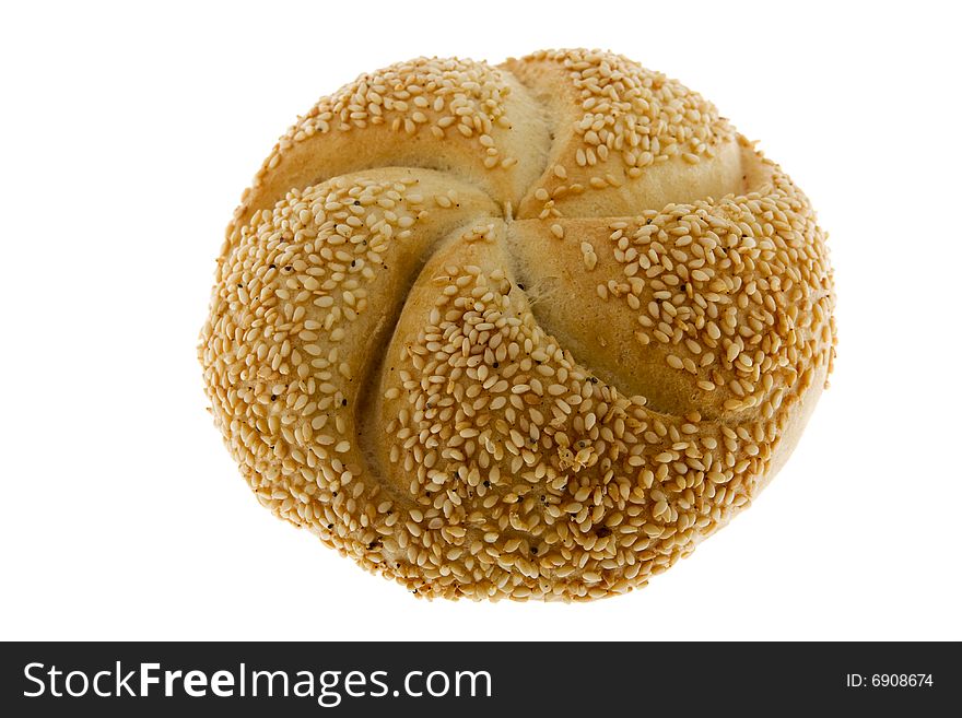 Roll with sesame against white background, fresh baking goods as a food