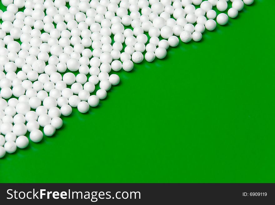 Christmas background with snow balls over green