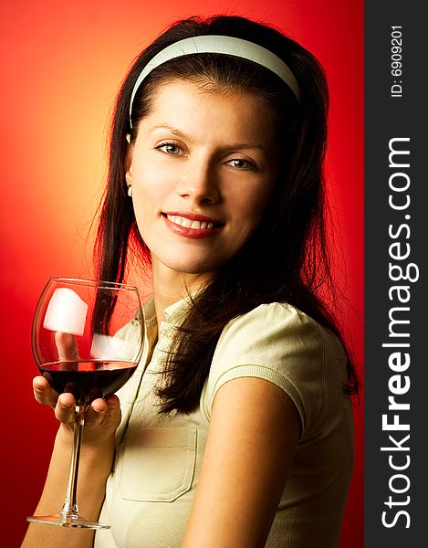 Young pretty caucasian woman with wine over red. Young pretty caucasian woman with wine over red