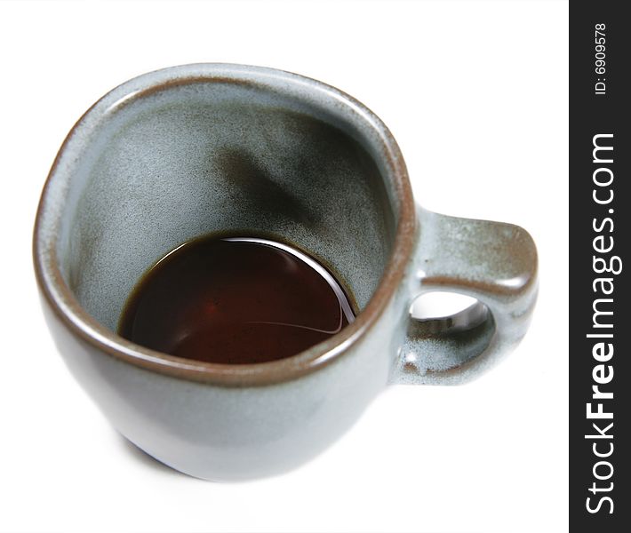 Looking down into a coffee cup with only a bit of coffee left down at the bottom, isolated on white. Looking down into a coffee cup with only a bit of coffee left down at the bottom, isolated on white.