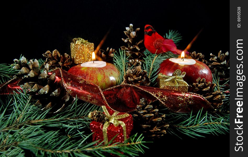 Glowing candles in apples with pine cones and cardinal. Glowing candles in apples with pine cones and cardinal.