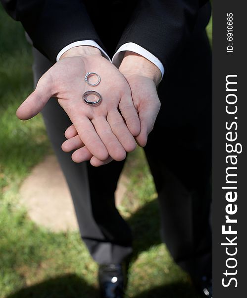 Hands holding wedding bands DOF focus on rings. Hands holding wedding bands DOF focus on rings
