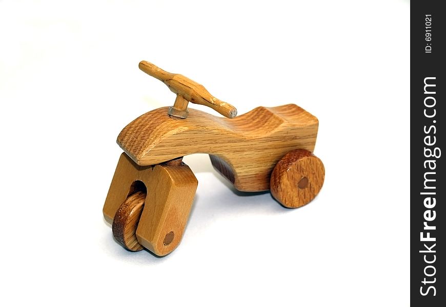 Wooden toy three-wheeler, front-view, on white background. Wooden toy three-wheeler, front-view, on white background.