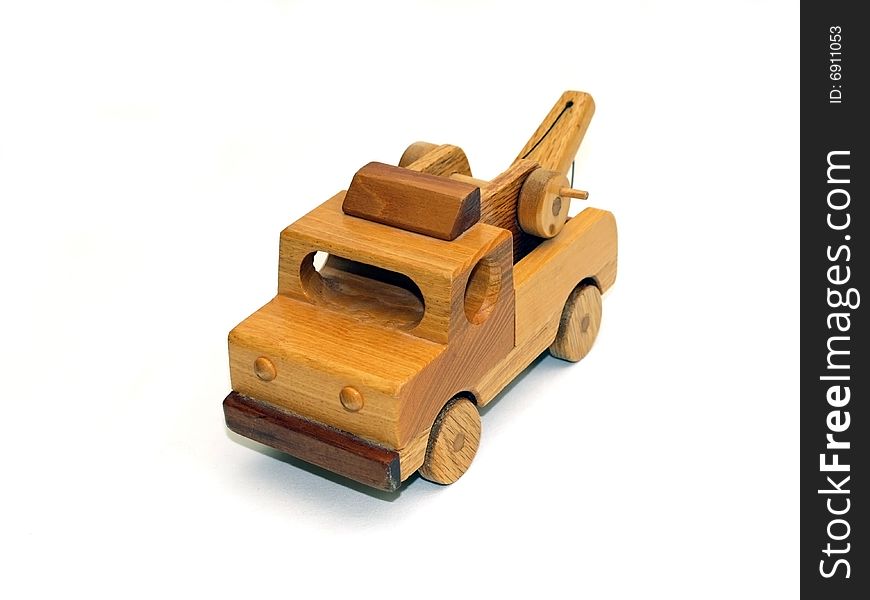 Wooden toy towtruck, front-view, on white background. Wooden toy towtruck, front-view, on white background.