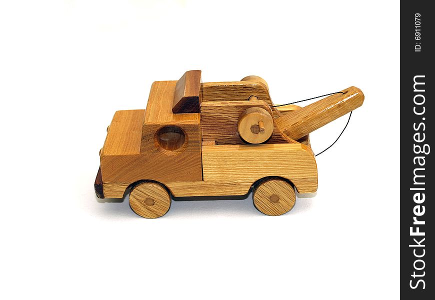 Wooden toy towtruck, side-view, on white background. Wooden toy towtruck, side-view, on white background.