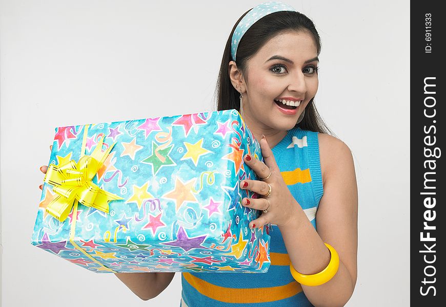 Asian girl of indian origin with a gift box. Asian girl of indian origin with a gift box