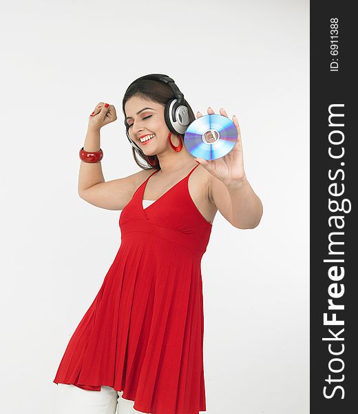 A sexy asian female of indian origin enjoying music. A sexy asian female of indian origin enjoying music