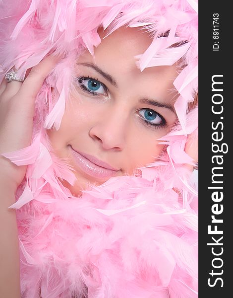 Beautiful young woman with a pink boa