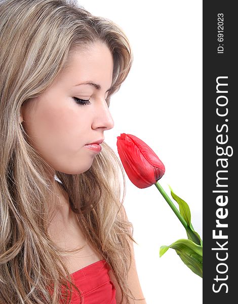 Romantic portrait of lovely young girl with red tulip