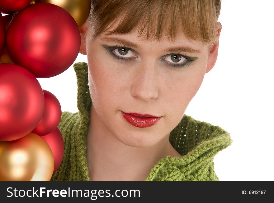 Close-up of young woman with red and gold Christmas balls on white background. Close-up of young woman with red and gold Christmas balls on white background