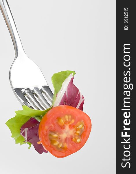 Fork with Fresh Salad isolated over white background. Fork with Fresh Salad isolated over white background