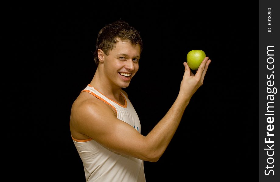 Young man with apple over black