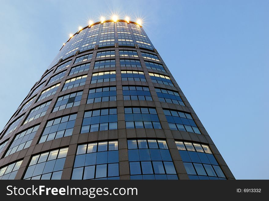 Blue mirrored walls of skyscraper with lights in Moscow (Russia). Blue mirrored walls of skyscraper with lights in Moscow (Russia)