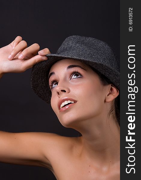 Young beautiful model posing with grey hat. Young beautiful model posing with grey hat