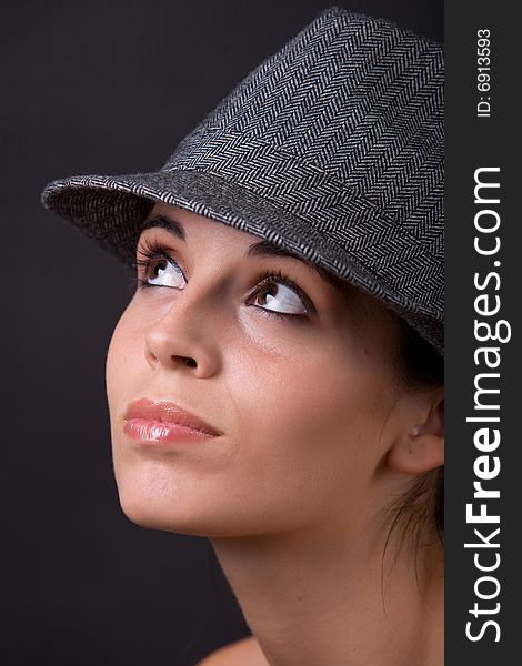 Young beautiful model posing with grey hat. Young beautiful model posing with grey hat