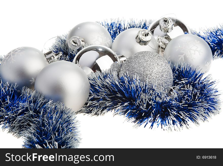 Silver Christmas balls surrounded by blue tinsel. Silver Christmas balls surrounded by blue tinsel