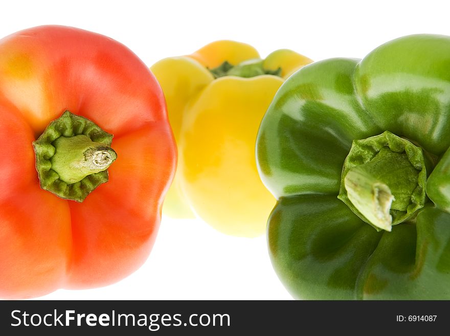 Peppers in three colors, against a white background isolate