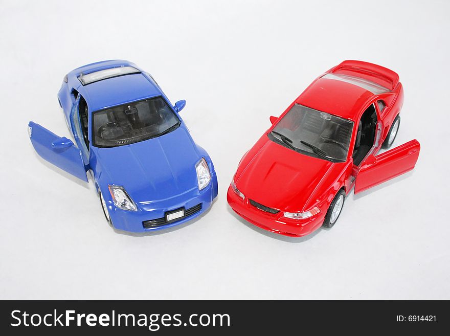 The two toy red and  blue  machine on a white background. The two toy red and  blue  machine on a white background