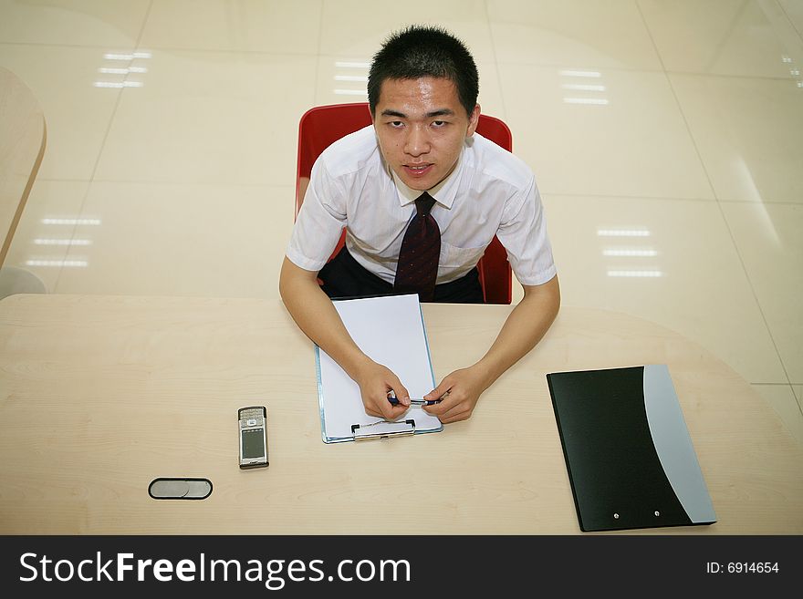 Young asian businessman in his office