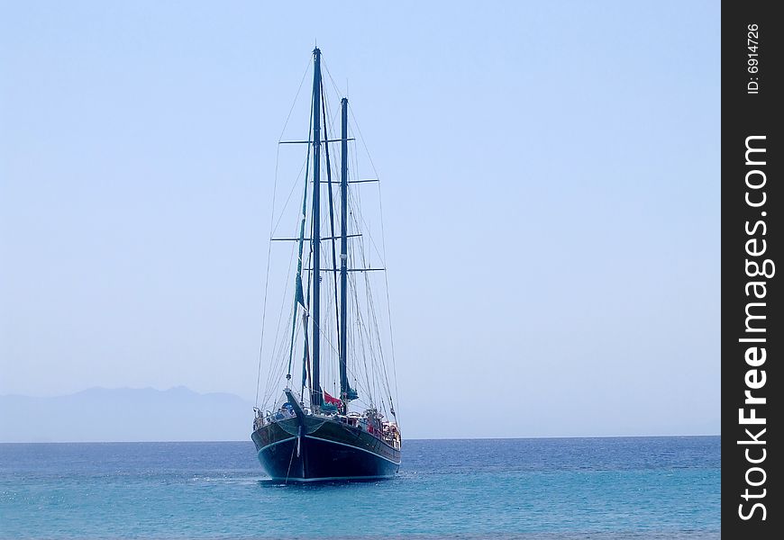 A yacht sailing off Paranga Beach, Mykonos, Greece. A yacht sailing off Paranga Beach, Mykonos, Greece