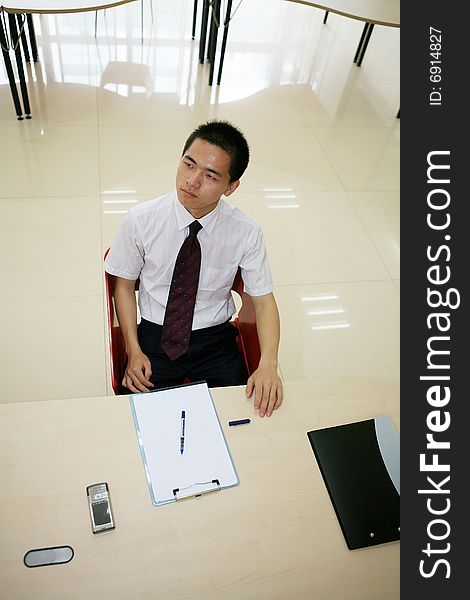 Young asian businessman in office