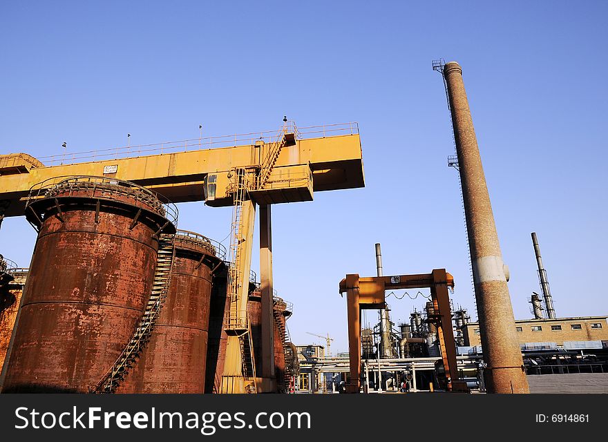 Crane, funnel and oil tanks in the factory. Crane, funnel and oil tanks in the factory