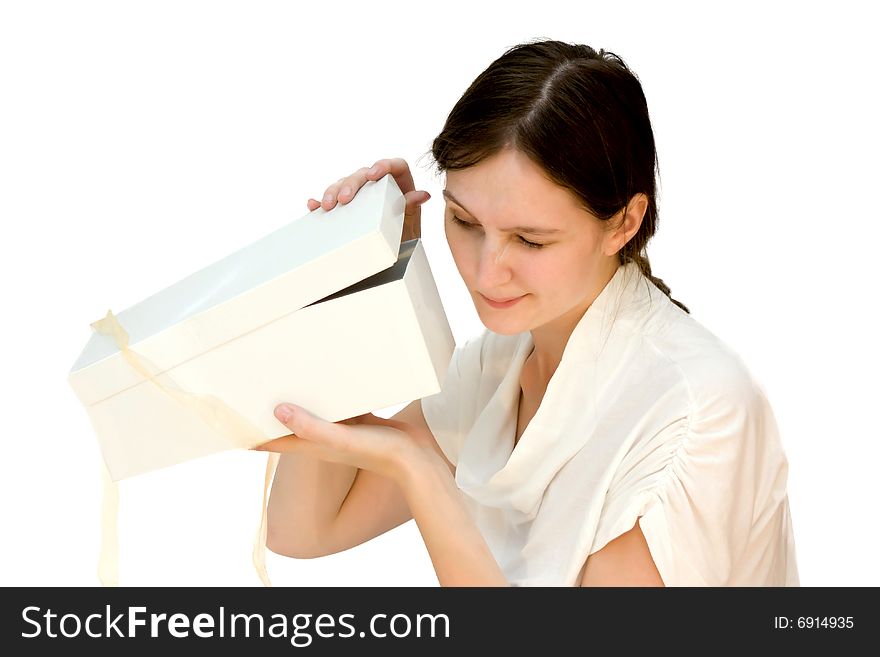 Young beautiful woman opening a box with present