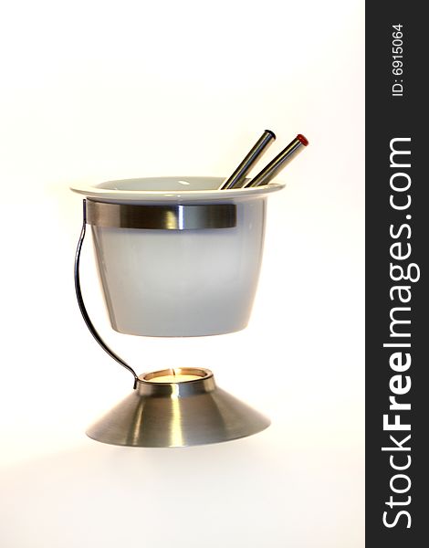 An isolated white fondue set.