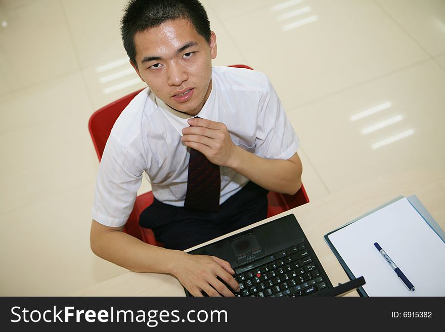 Young asian businessman in his office