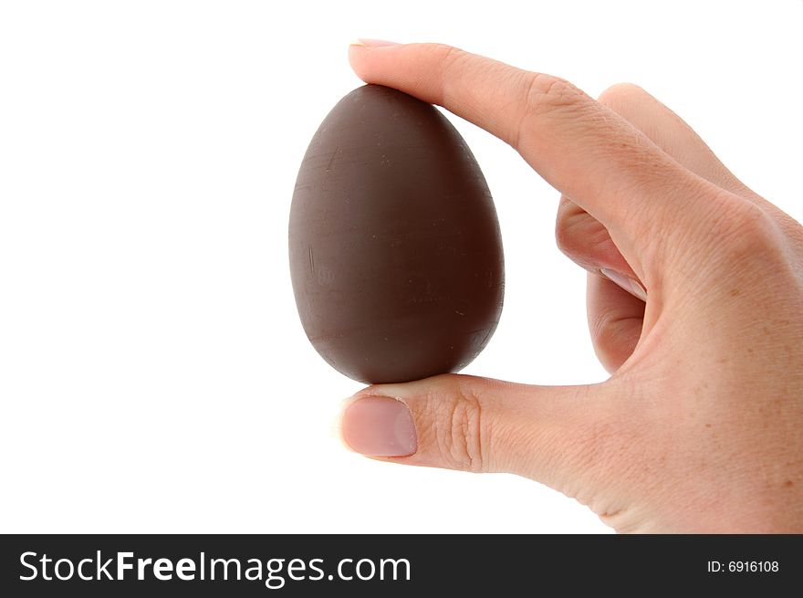 An Isolated to White photo of a mini Easter Egg with toy held between fingers. An Isolated to White photo of a mini Easter Egg with toy held between fingers