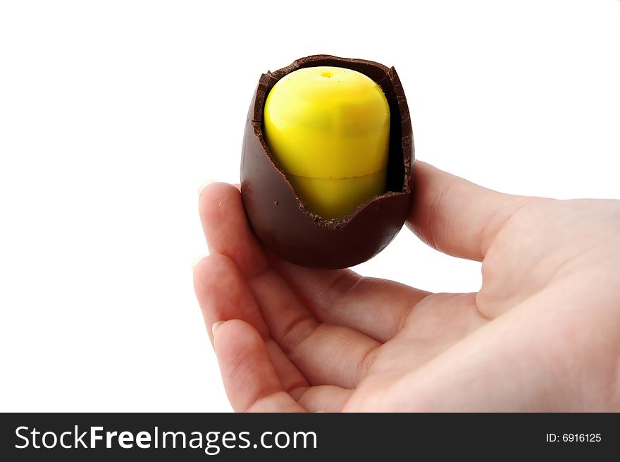 An Isolated to White photo of a mini Easter Egg with toy inside, almost eaten. An Isolated to White photo of a mini Easter Egg with toy inside, almost eaten