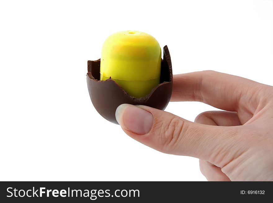 An Isolated to White photo of a mini Easter Egg with toy inside nearly finished. An Isolated to White photo of a mini Easter Egg with toy inside nearly finished