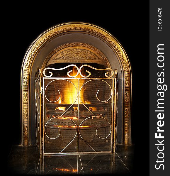 Antique golden fireplace with live fire over black background. Antique golden fireplace with live fire over black background