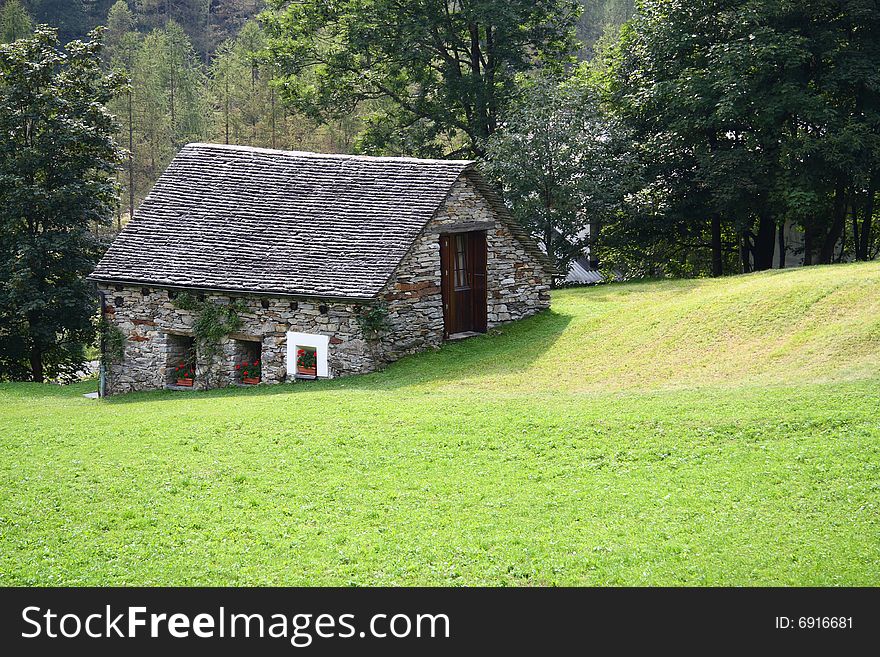 Mountain stone house in the Swiss Alps