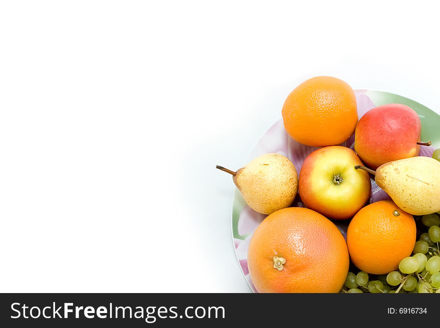 Oranges, grapefruits and grapes on the dish. Oranges, grapefruits and grapes on the dish
