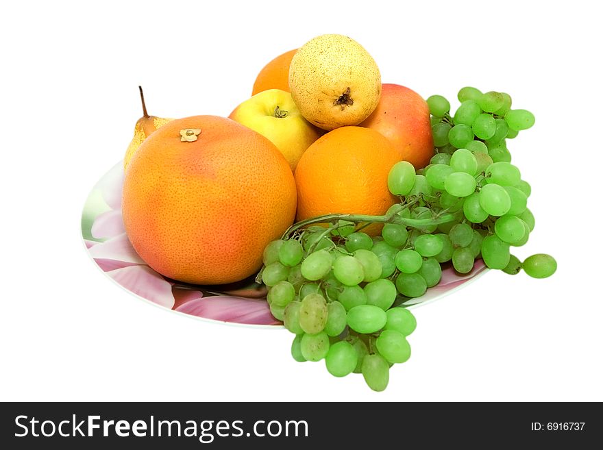 Oranges, apples, grapefruits and grapes on the dish. Oranges, apples, grapefruits and grapes on the dish