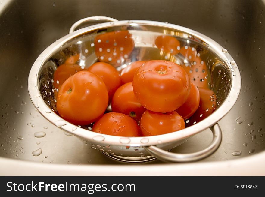 Close-up of fresh tomatos in silver strainer