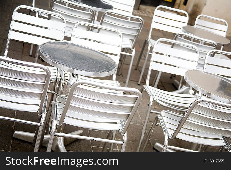 Empty outdoor restaurant with metal chairs and tables