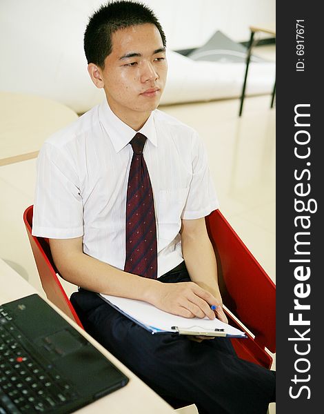 Young asian businessman in office