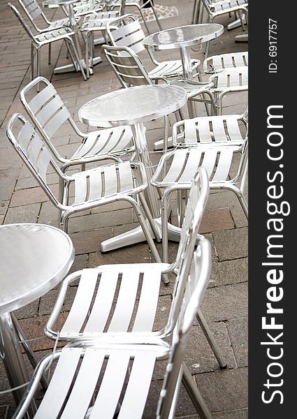 Empty outdoor restaurant with metal chairs and tables