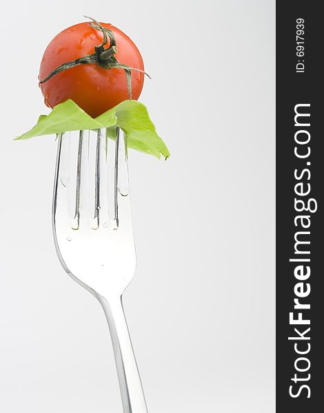 Fork with Fresh Salad isolated over white background. Fork with Fresh Salad isolated over white background