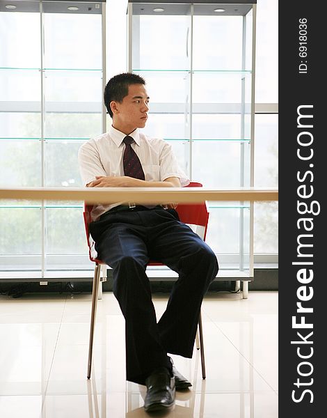 Young Businessman Sit In Office
