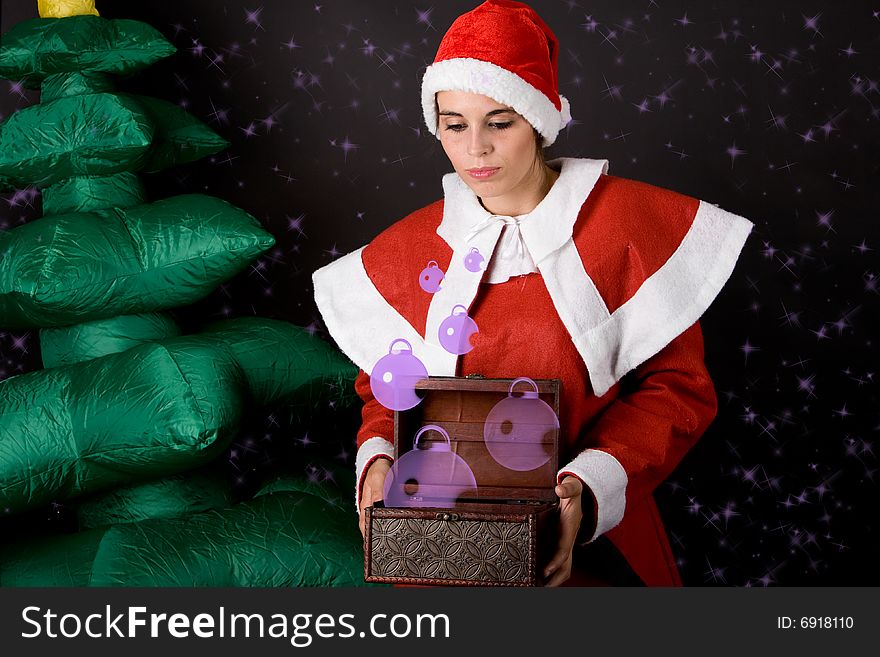 Beautiful sexy girl wearing santa claus clothes near christmas tree